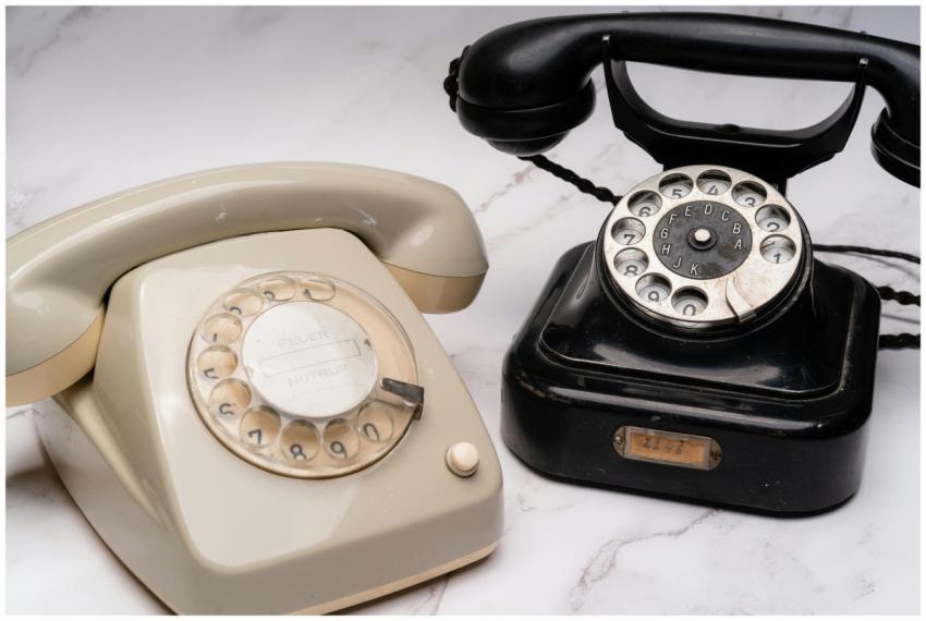 Two classic rotary dial telephones, one black and