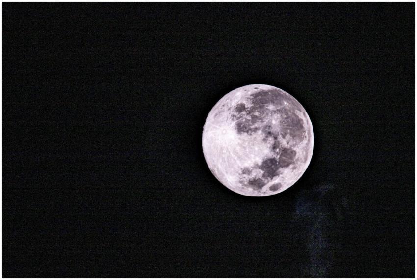 Bright full moon glowing against a dark, black sky