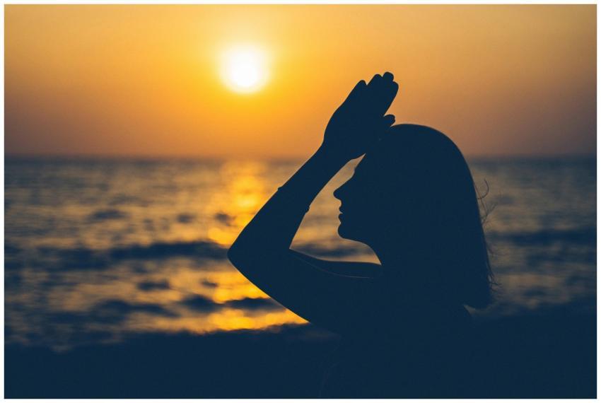 Side view of unrecognizable female with raised arm