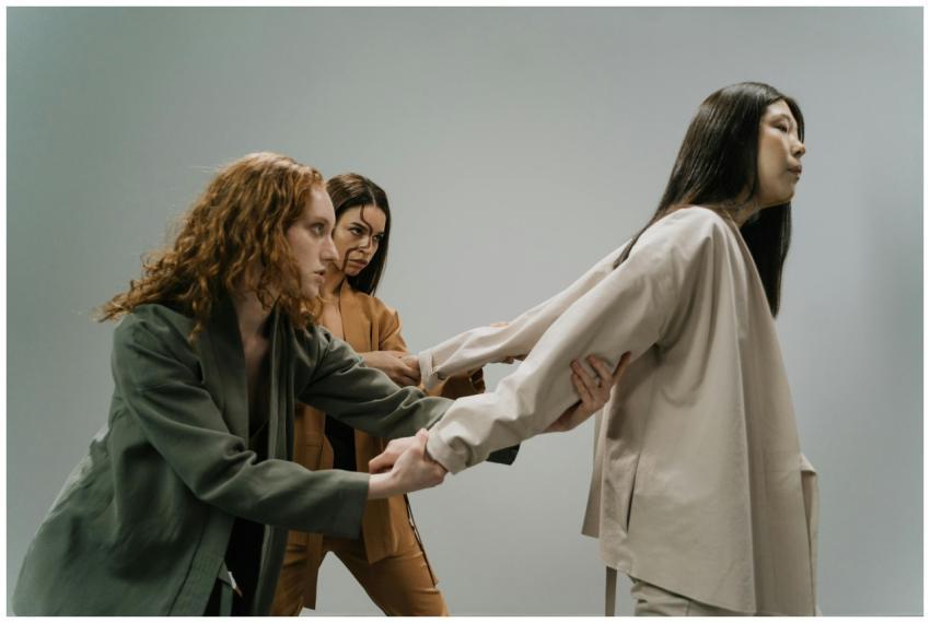 Three women in a conceptual studio shoot conveying