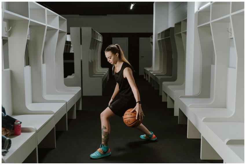 A female basketball player practicing dribbling in