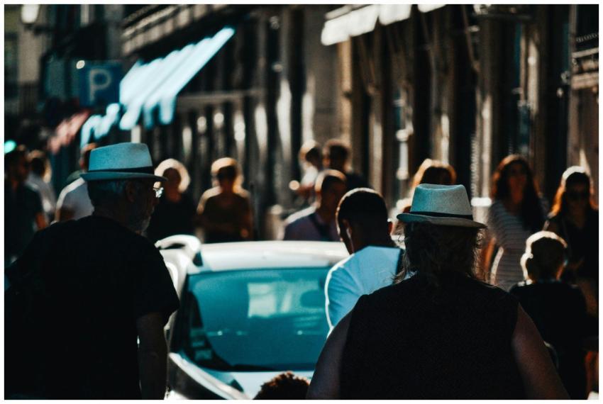 A bustling urban street filled with people walking