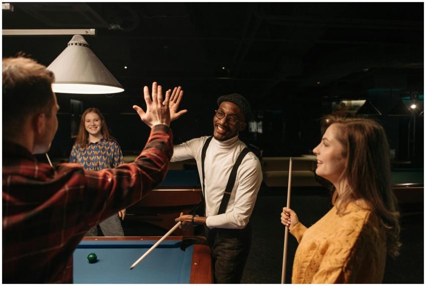 Group of diverse friends having fun playing billia