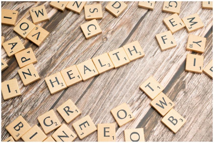 Scrabble tiles spelling 'HEALTH' on wooden surface