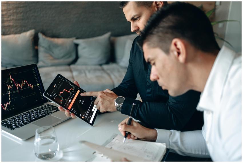 Business professionals reviewing stock market grap