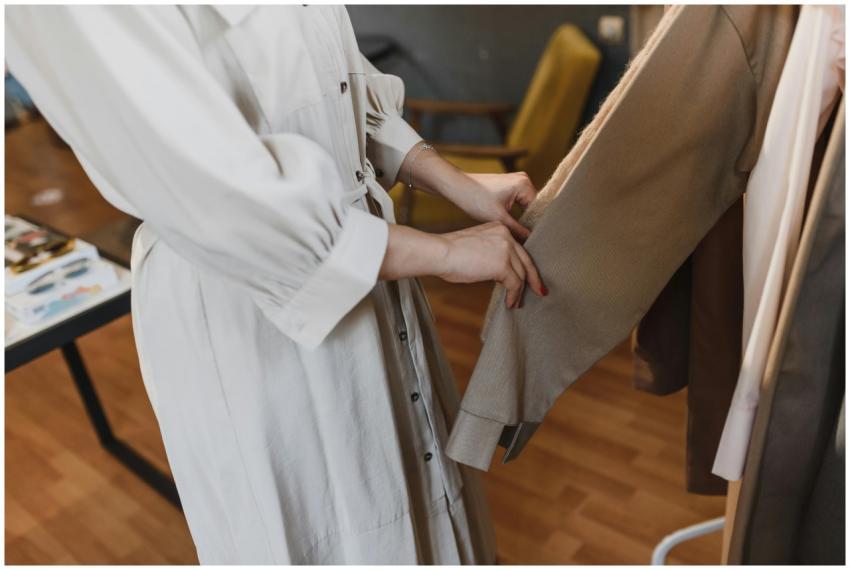 A woman examining clothing inside a store, highlig