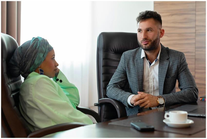 Two professionals in a business meeting discussing