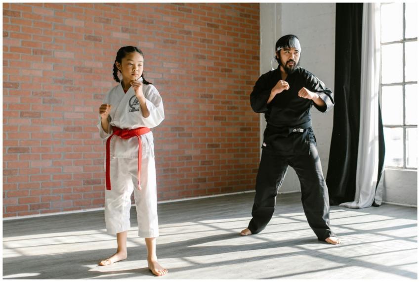 A child and adult practicing martial arts in a bri