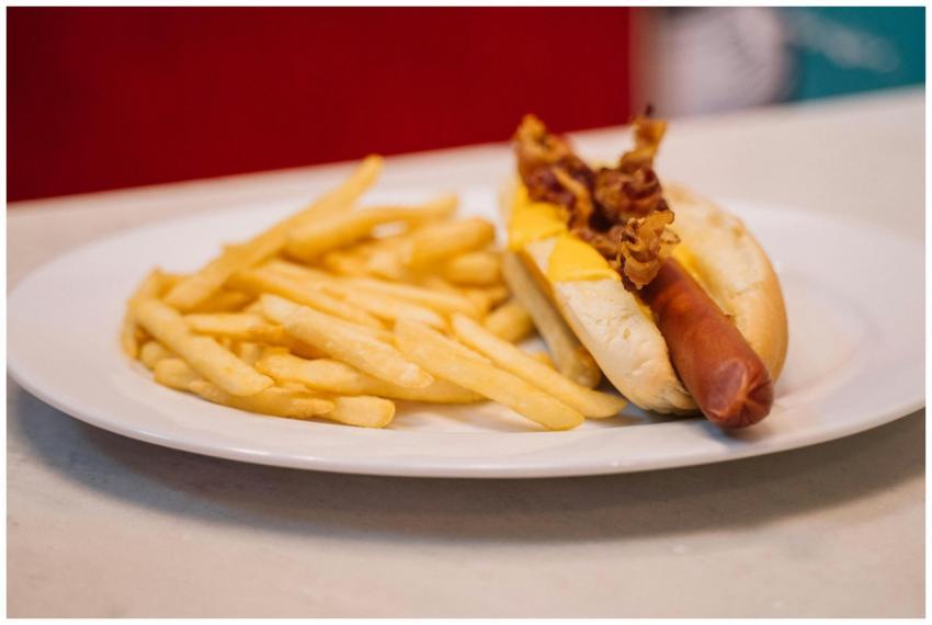 A mouth-watering bacon hotdog paired with crispy g