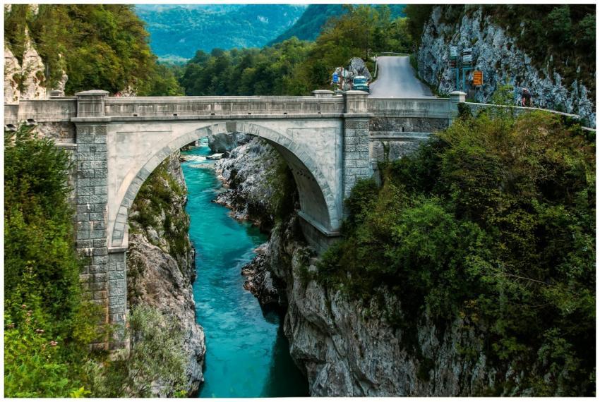 Scenic view of a stone arch bridge over a vibrant