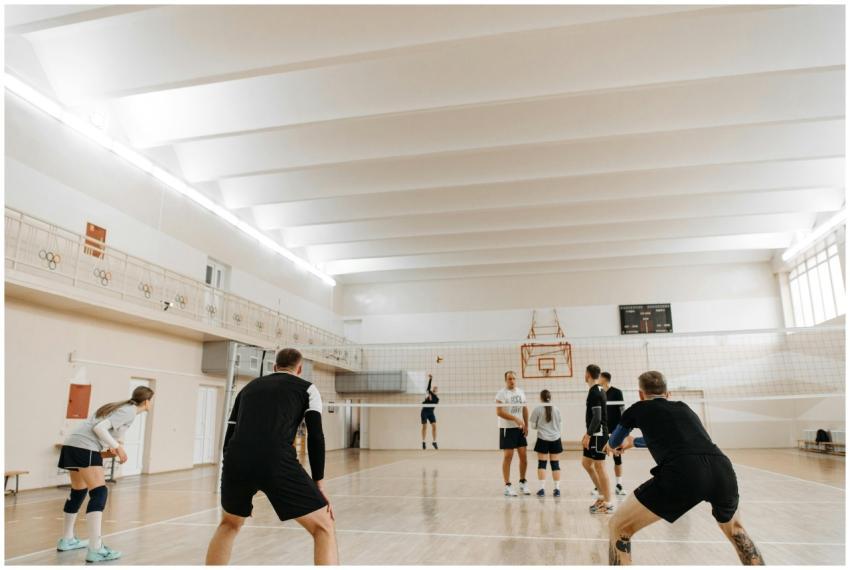 A group of athletes engaged in an indoor volleybal