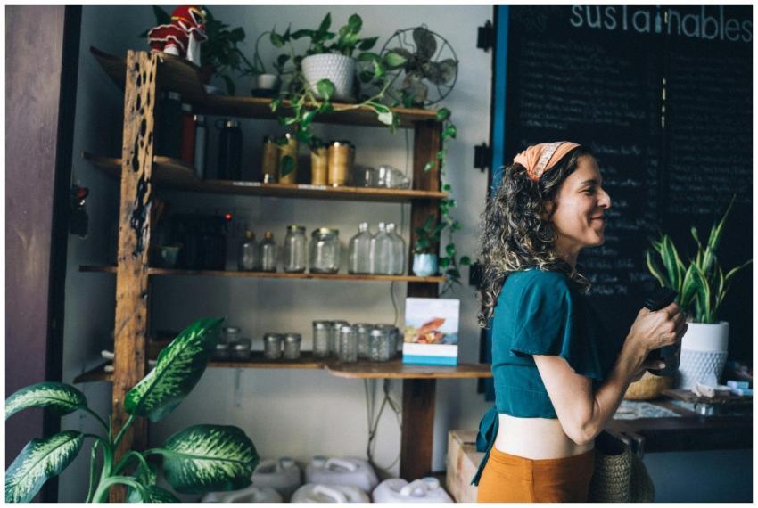 A smiling woman with a bandana in a sustainable st