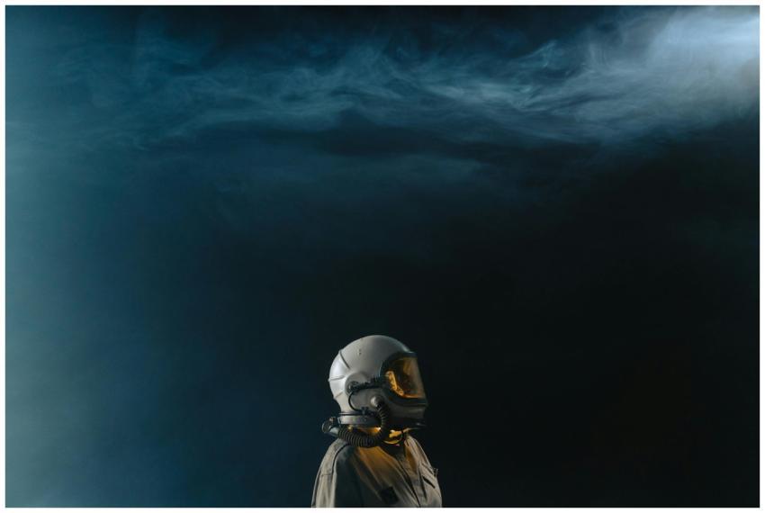 Astronaut in a helmet looks toward the stars in a