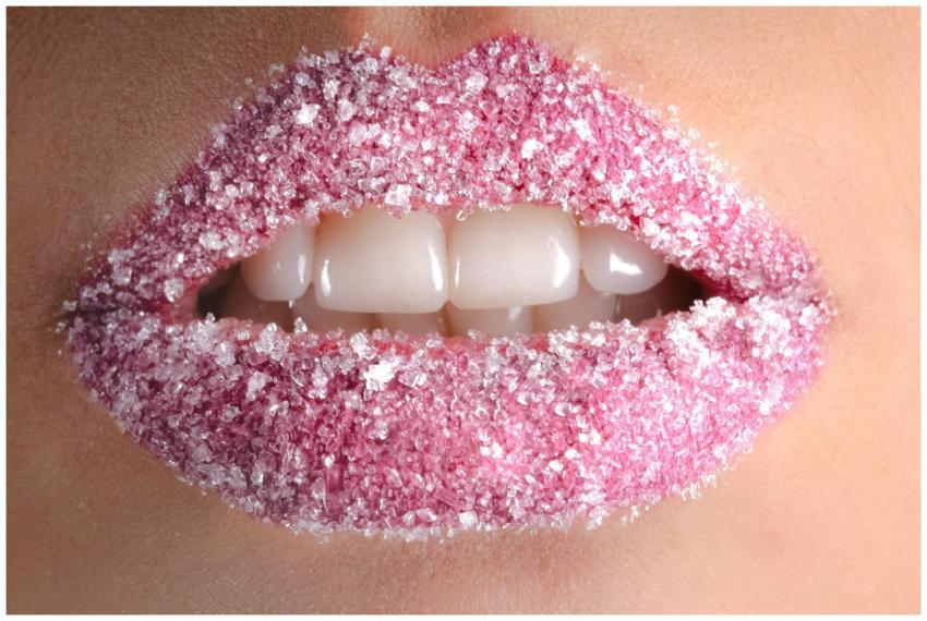 Artistic close-up of lips coated with pink sugar c
