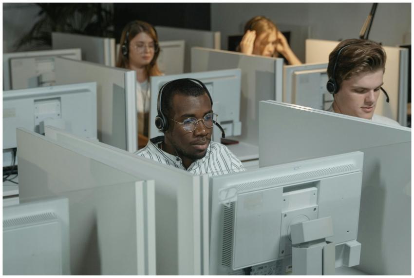 Focused call center agents working in an office en
