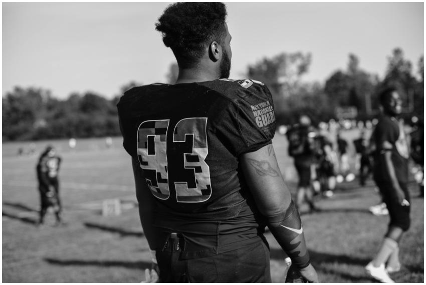 Black and white image of a football player wearing