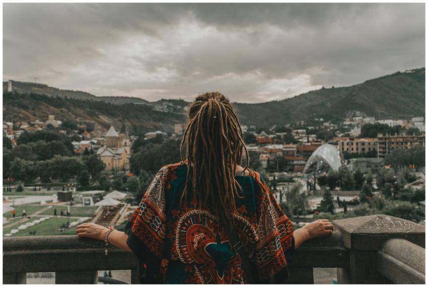 A person with dreadlocks overlooking the scenic ci