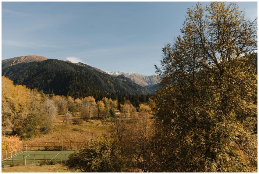 Autumn view of a mountain landscape with a tennis