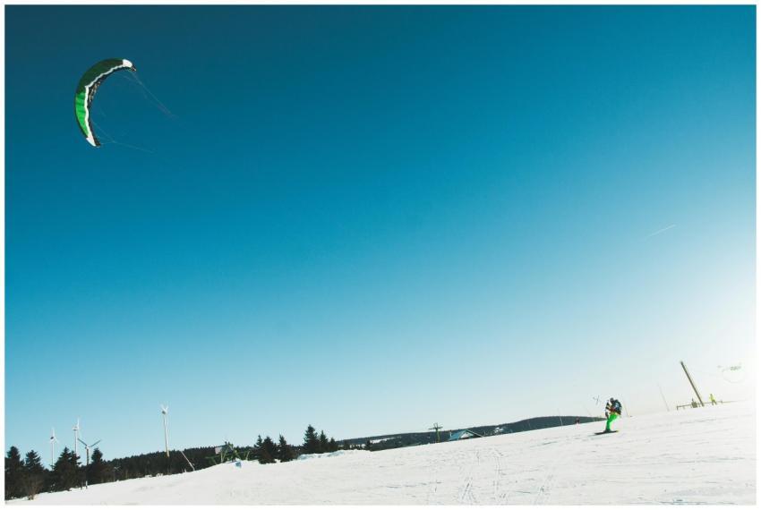 Snowkiter enjoying an exhilarating ride on a sunny