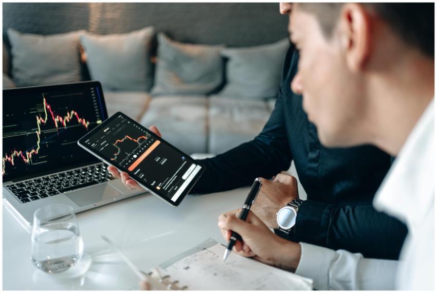 Colleagues in formal wear discussing market trends