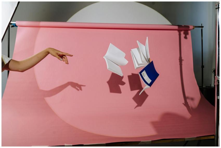 Artistic composition with flying notebooks and han