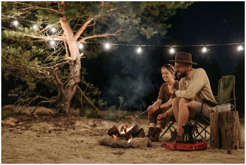 Couple enjoying a cozy camping night by a bonfire