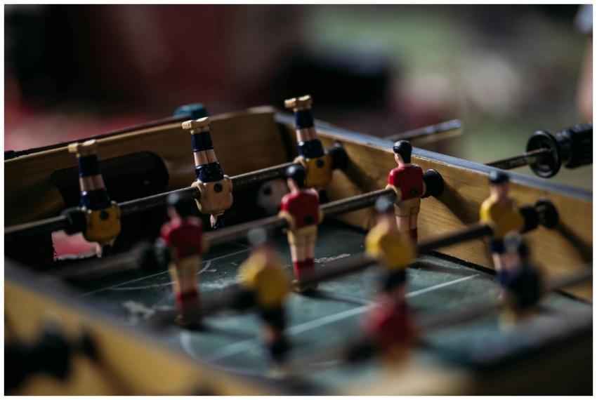 Close-up of a foosball table with miniature soccer