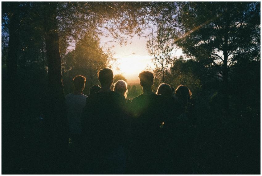 A group of friends enjoying a scenic sunset in a f