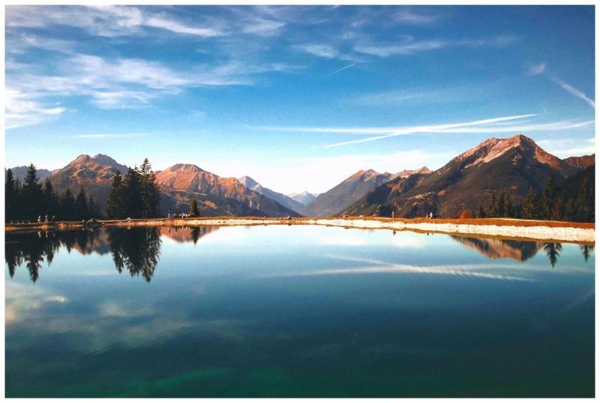 Peaceful mountain lake reflecting the surrounding