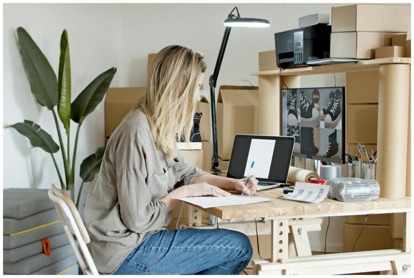 A young woman managing her online store startup, w