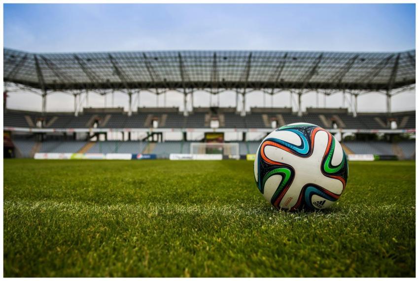Close-up of a soccer ball on a lush grass field wi