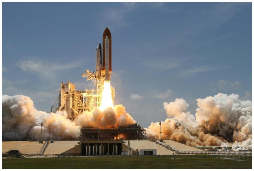 A NASA space shuttle launches with fiery liftoff,