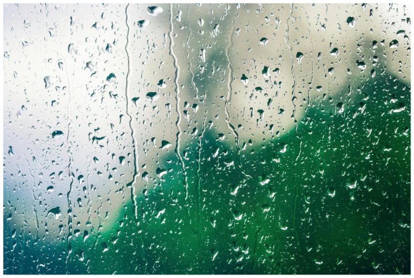 Raindrops on a glass window create a soothing patt