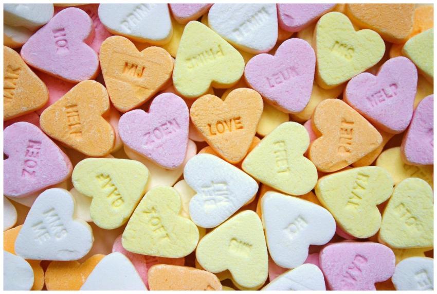 Colorful heart-shaped candies with embossed love m