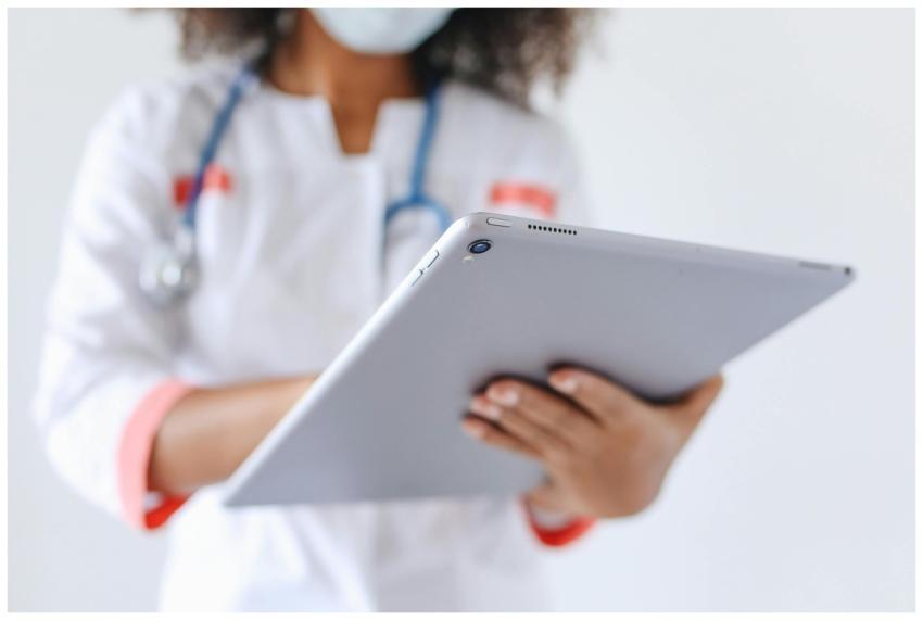 Close-up of a doctor wearing a mask using a tablet
