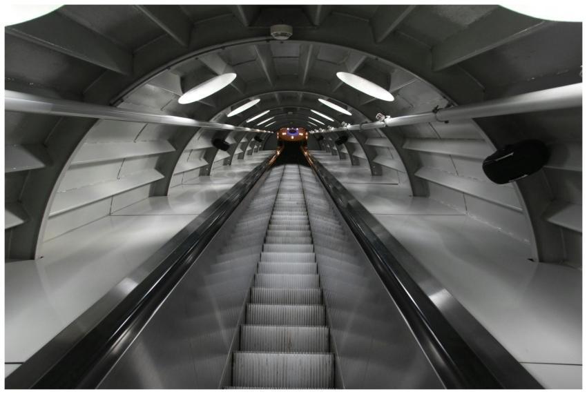 A sleek and modern underground escalator tunnel wi