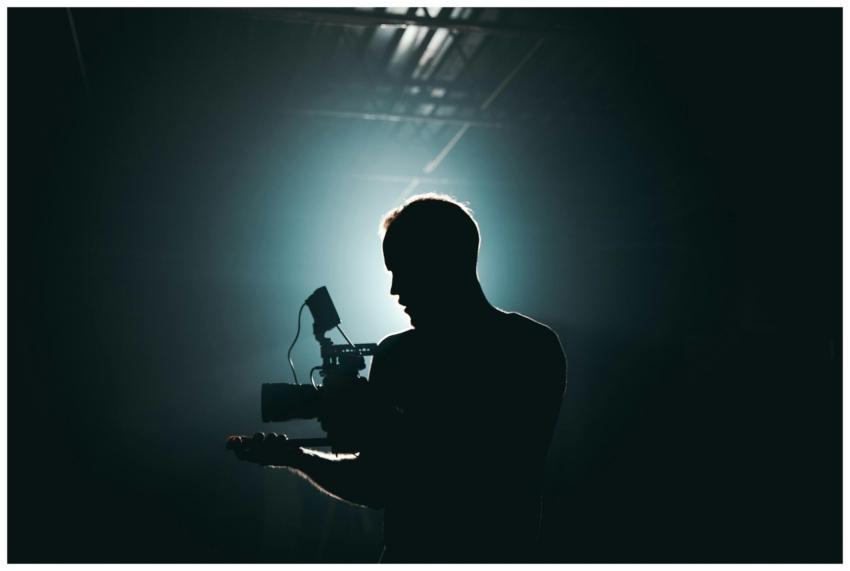 Silhouette of a cinematographer with camera gear i