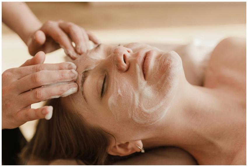 A close-up of a woman receiving a soothing facial
