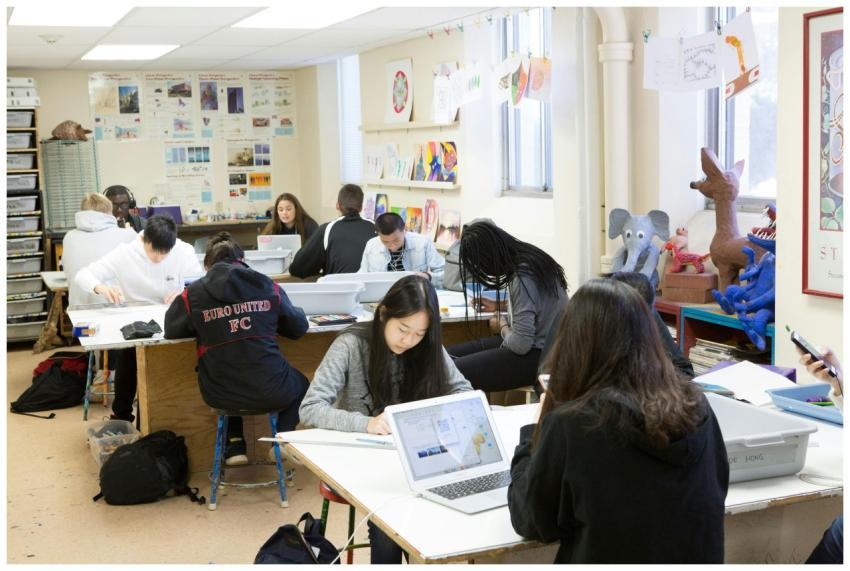 A group of diverse students studying and collabora