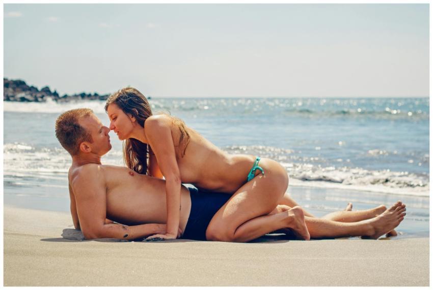 A couple enjoying a romantic moment on a sunny bea