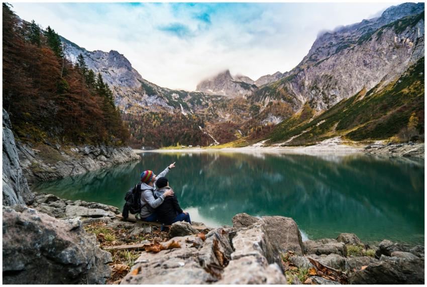 A couple enjoys a scenic view of Hallstatt Lake su