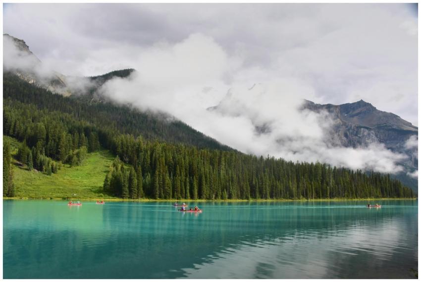 Canoeing on a pristine turquoise lake surrounded b