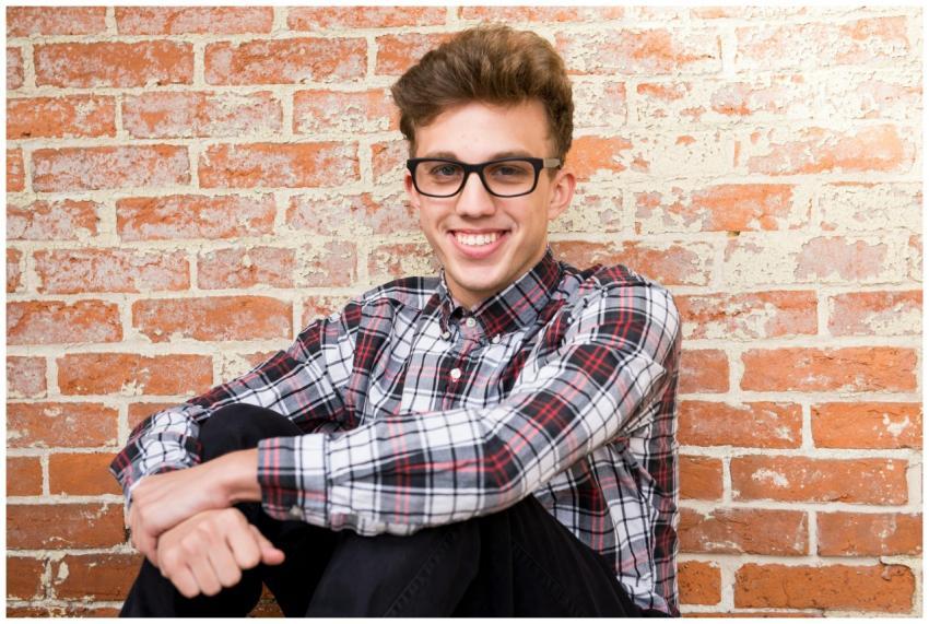 Casual portrait of a smiling young man in glasses