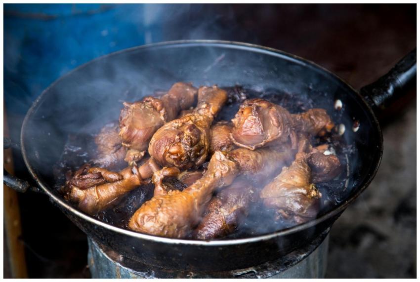 Close-up of juicy smoked chicken drumsticks cookin