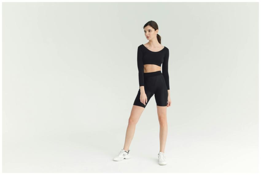 A sporty young woman poses confidently in stylish