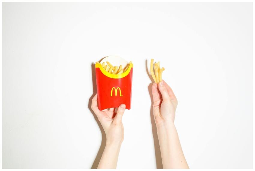 Close-up of hands holding McDonald's french fries