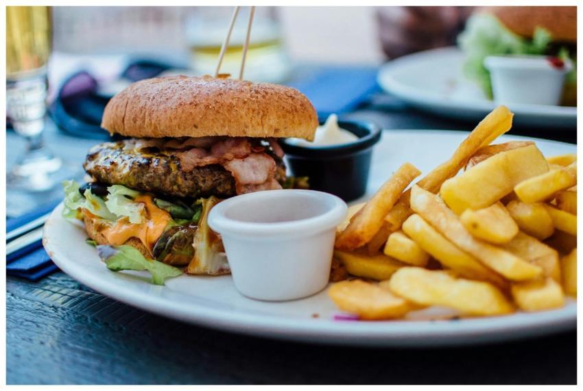 Close-up of a juicy burger and crispy fries served