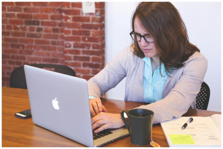 Young woman working on a laptop at a modern office