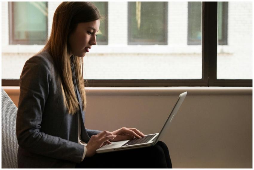 Professional woman using laptop in modern indoor s