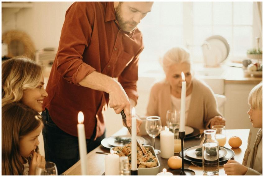 A warm family gathering around a festive Thanksgiv